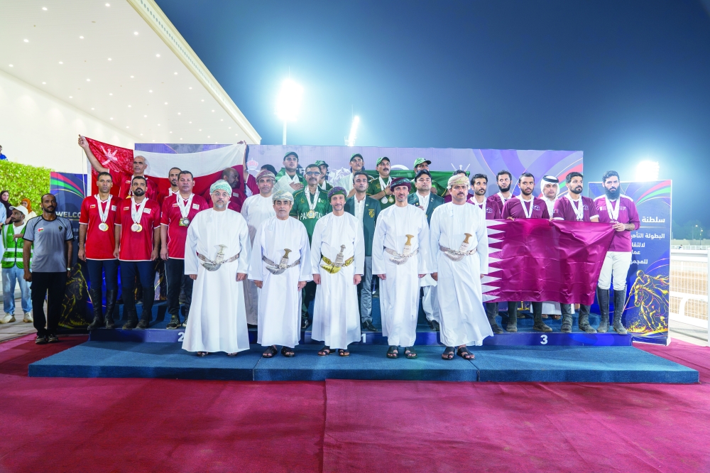 The podium winners celebrate their achievements after the final round. — Asaad al Badri